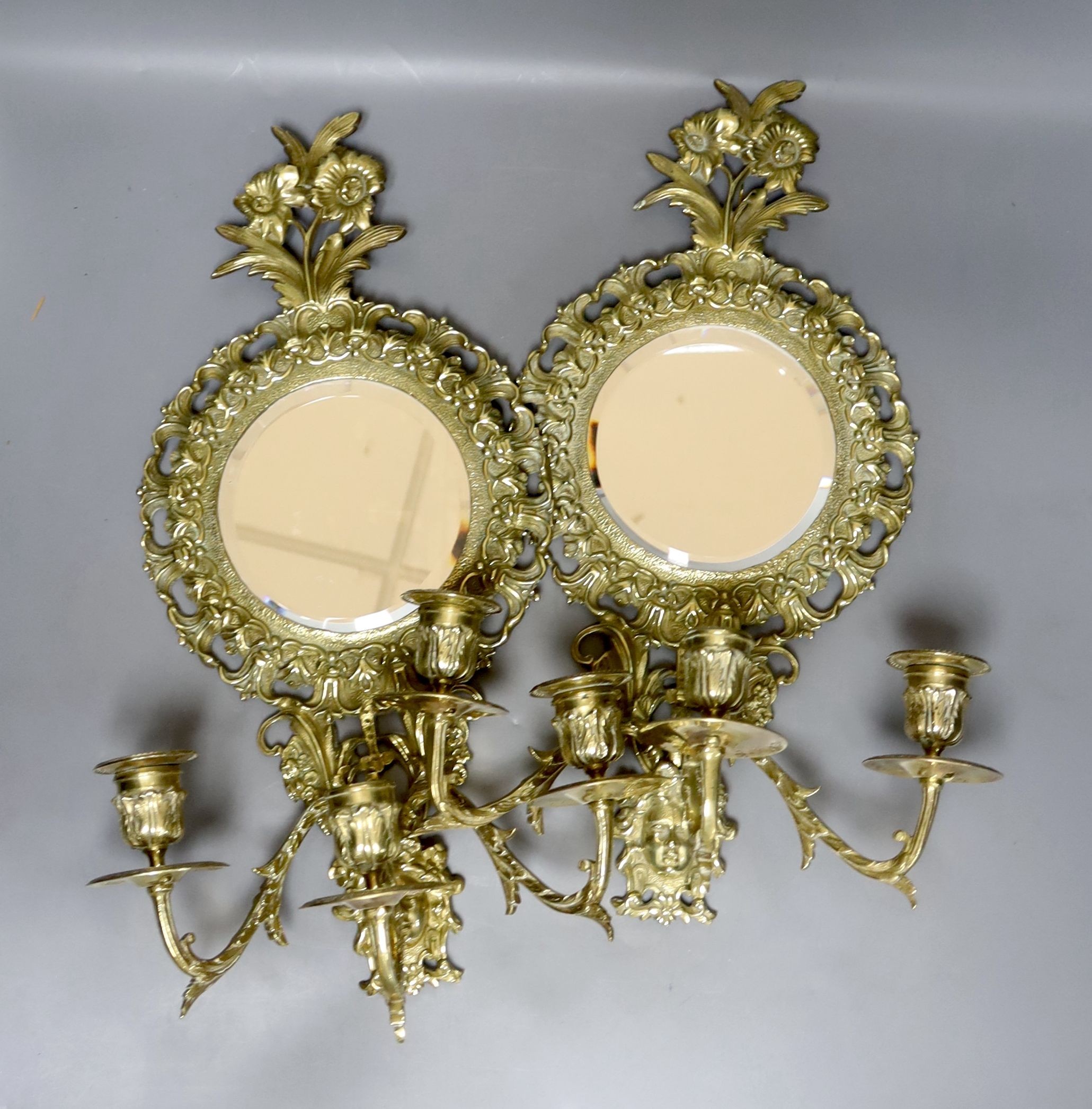 A pair of late 19th century French cast brass three sconce girandoles, height 42cm